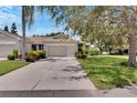 Two-car garage, well-maintained landscaping, and a spacious driveway at 1015 Radison Lake Ct # 65, Sun City Center, FL 33573