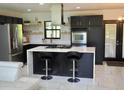 Modern kitchen with stainless steel appliances and a large island at 26638 Green Willow Run, Wesley Chapel, FL 33544