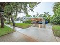 House exterior view, showcasing the carport and landscaping at 1837 Worrington St, Sarasota, FL 34231