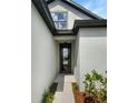 Modern black front door with glass panel at 13292 Sea Bridge Dr, Hudson, FL 34669