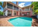 Private pool with brick deck and access from a two-story home at 825 Islebay Dr, Apollo Beach, FL 33572