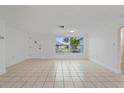 Bright living room with tile floors and large windows at 1332 Maybury Dr, Holiday, FL 34691