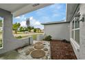 Inviting front porch with a stone pathway and landscaping at 1332 Maybury Dr, Holiday, FL 34691
