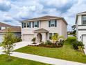 Two-story house with gray siding and blue shutters at 13090 Brookside Moss Dr, Riverview, FL 33579