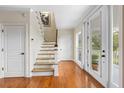 Bright foyer with hardwood floors and staircase at 1215 Bayshore Dr, Terra Ceia, FL 34250