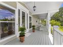Inviting porch with wicker seating and views of lush surroundings at 1215 Bayshore Dr, Terra Ceia, FL 34250