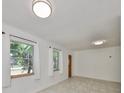 Bright, airy living room with large windows, updated lighting, and sleek tile flooring at 3908 W Wallace Ave, Tampa, FL 33611