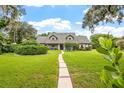 House with gray roof and lush green lawn at 1810 S Valrico Rd, Valrico, FL 33596