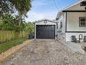 Detached garage with black door and gravel driveway at 9913 Alavista Dr, Gibsonton, FL 33534
