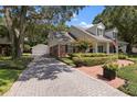 Brick house with a spacious driveway and landscaping at 1506 S Sheridan Forest Dr, Tampa, FL 33629