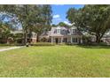 House with manicured lawn and mature trees at 1506 S Sheridan Forest Dr, Tampa, FL 33629