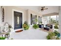 Inviting front porch features a comfortable seating area and lush plants at 617 Islebay Dr, Apollo Beach, FL 33572