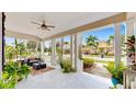 Inviting front porch features comfortable seating, ceiling fan, potted plants, and views of the lovely neighborhood street at 617 Islebay Dr, Apollo Beach, FL 33572