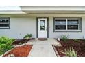 White front door entrance with landscaping at 5805 8Th Avenue W Dr, Bradenton, FL 34209