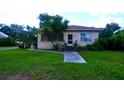 Brick ranch home with a walkway and landscaped yard at 14141 11Th St, Dade City, FL 33525