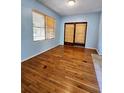 Light-blue living room with hardwood floors and sliding glass doors at 14141 11Th St, Dade City, FL 33525