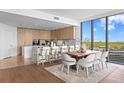Gourmet kitchen and dining area with custom cabinets, marble countertops, and floor-to-ceiling windows at 2912 Santiago St # 1201, Tampa, FL 33629