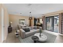 Living room with light flooring and access to the backyard at 15635 Bear Creek Dr, Tampa, FL 33624