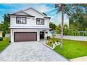 Two-story home with modern design and paver driveway at 1105 Conant Ave, Safety Harbor, FL 34695