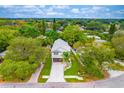 Two-story home nestled amongst lush green trees at 1105 Conant Ave, Safety Harbor, FL 34695