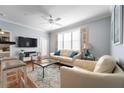 Bright living room featuring a comfy sofa, flat-screen TV and wood floors at 501 Knights Run Ave # 2120, Tampa, FL 33602