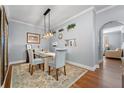 Elegant dining room with a glass-top table, chandelier, and hardwood floors at 501 Knights Run Ave # 2120, Tampa, FL 33602