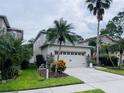 Two-story house with a two-car garage and landscaped front yard at 2348 Silvermoss Dr, Wesley Chapel, FL 33544