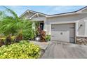 Single story home with two car garage and lush landscaping at 13012 Rain Lily Dr, Riverview, FL 33579