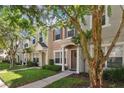 Two story townhome with light colored siding and brown door at 4538 Kennewick Pl, Riverview, FL 33578