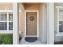 Inviting front door entrance with a wreath, leading into a charming home at 4538 Kennewick Pl, Riverview, FL 33578