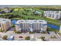 Condo building with parking and a view of a golf course at 960 Starkey Rd # 7506, Largo, FL 33771