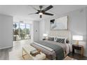 Spacious bedroom with a comfortable bed and balcony access at 7400 Sun Island S Dr # 304, South Pasadena, FL 33707