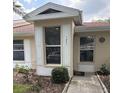 Charming home entrance featuring decorative shutters, house number and well maintained landscaping at 120 Knollpoint Dr, Sun City Center, FL 33573