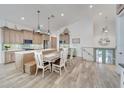 Spacious kitchen with island, light wood cabinets and modern appliances at 833 Bay Point Dr, Madeira Beach, FL 33708