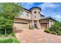 Two-story house with a three car garage and landscaped yard at 2924 Valencia Ridge St, Valrico, FL 33596