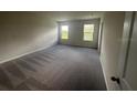 Spacious carpeted bedroom with two windows offering natural light at 708 160Th E Ln, Bradenton, FL 34212