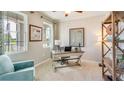 Bright home office with built-in shelving and a comfortable seating area at 708 160Th E Ln, Bradenton, FL 34212