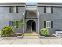Gray condo building with entrance and landscaping at 3822 Cortez Dr # D, Tampa, FL 33614