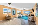 Inviting living room featuring a view of the bay, neutral walls, and a mix of tile and wood flooring at 4550 Cove Cir # 501, St Petersburg, FL 33708