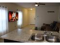 Kitchen with a breakfast bar and view into the living room at 11919 Grand Kempston Dr, Gibsonton, FL 33534