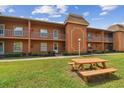 Building exterior showcasing a picnic table and ample green space at 12760 Indian Rocks Rd # 910, Largo, FL 33774