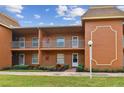 Two-story building, featuring multiple units with balconies and well-maintained landscaping at 12760 Indian Rocks Rd # 910, Largo, FL 33774