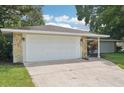 White double-car garage with stone accents on the exterior at 6605 Pointe West Blvd, Bradenton, FL 34209