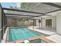 Inviting swimming pool with a screened enclosure and brick coping at 6605 Pointe West Blvd, Bradenton, FL 34209