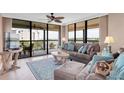 Spacious living room with light flooring, comfy seating, and water views at 11590 Shipwatch Dr # 548, Largo, FL 33774