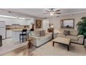 Comfortable living room with a ceiling fan, white sofas, and an open kitchen at 12760 Indian Rocks Rd # 510, Largo, FL 33774