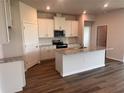 Bright kitchen featuring white cabinets, stainless steel appliances, and an island with granite countertops at 18208 Beach Ranch Ter, Lakewood Ranch, FL 34211