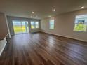 Spacious living room with wood floors and large windows providing plenty of natural light at 18208 Beach Ranch Ter, Lakewood Ranch, FL 34211