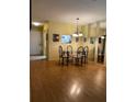 Spacious dining area with laminate floors and a chandelier at 601 N Hercules Ave # 103, Clearwater, FL 33765