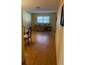 Bright living room with laminate floors and a floral couch at 601 N Hercules Ave # 103, Clearwater, FL 33765